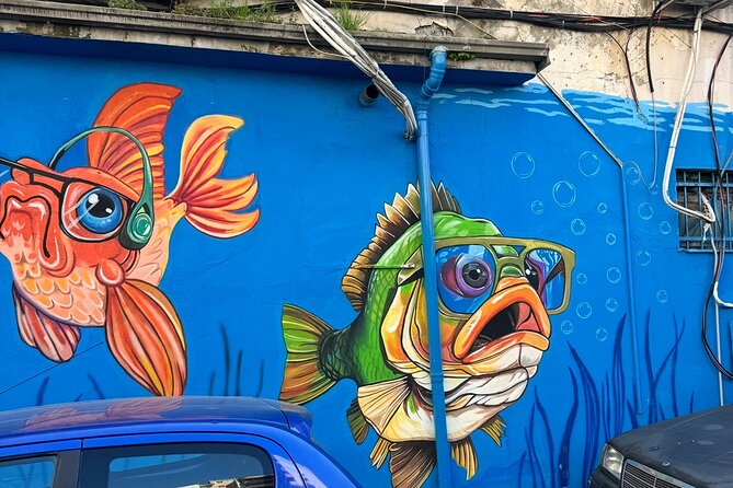 Tirana Mural Bike Tour: Street Art, Culture & Photography Stops - Smaller murals with big weirdness: DOG, Mots, and surreal pause time